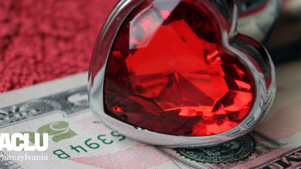 heart-shaped ring and fifty dollar bill