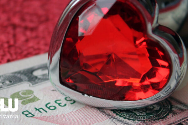 heart-shaped ring and fifty dollar bill