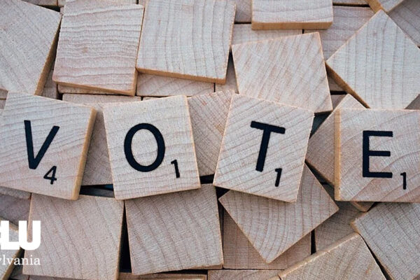 Scrabble tiles spelling out 'Vote'