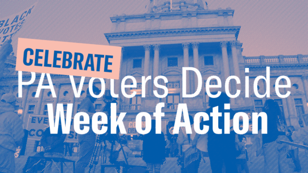 Ralliers standing in front of the Pennsylvania State Capitol in Harrisburg while describing the name and date of the event