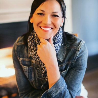 A picture of Elizabeth Randol smiling and sitting with a chair