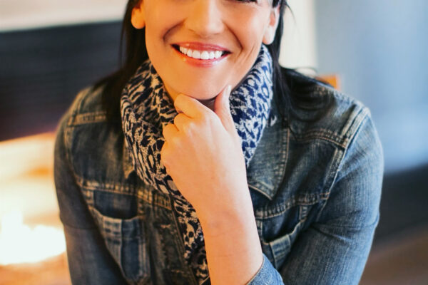A picture of Elizabeth Randol smiling and sitting with a chair