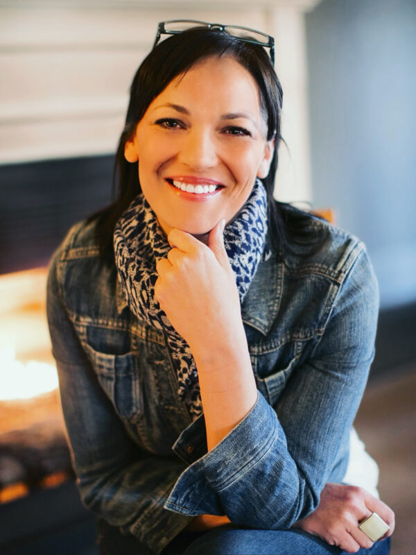 A picture of Elizabeth Randol smiling and sitting with a chair