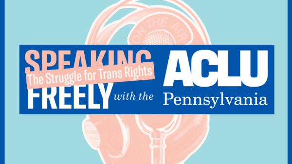 A pink microphone behind pink headphones on a light blue background.