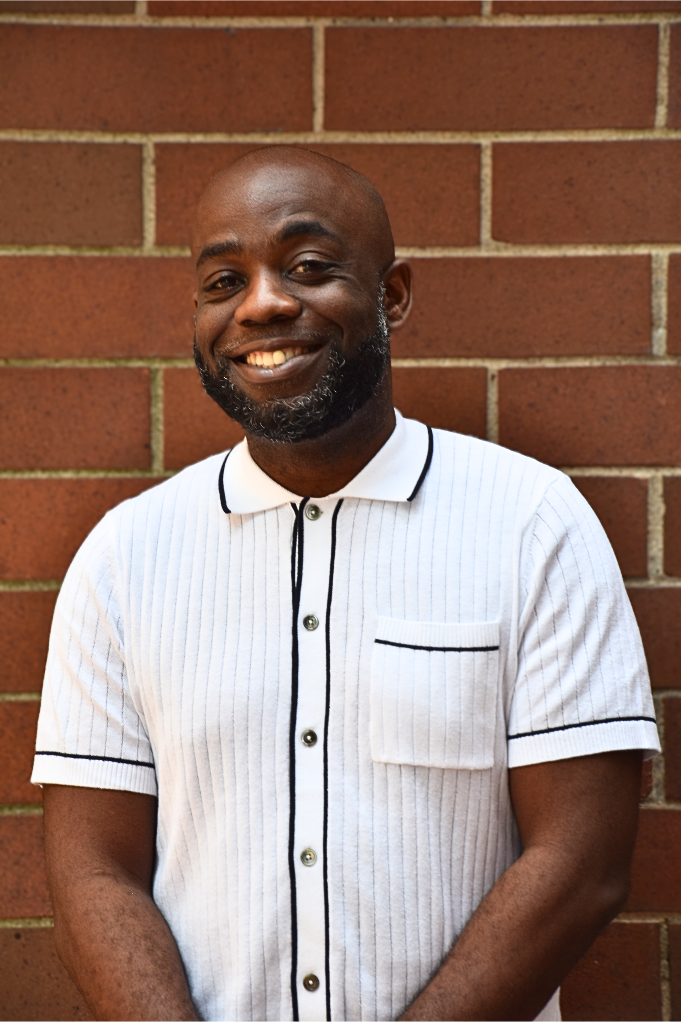 A picture of Tyree Williams smiling in a white and black button down shirt