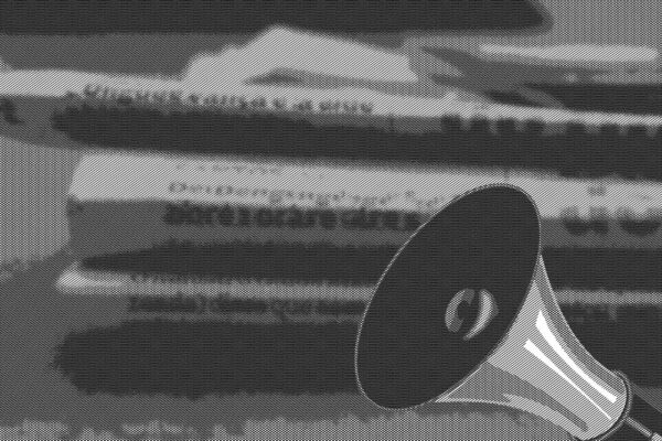 megaphone and stack of newspapers