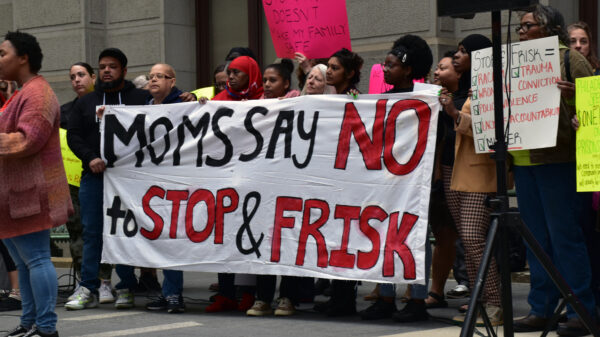 Group of demonstrators holding a banner reading "Moms say no to stop and frisk"