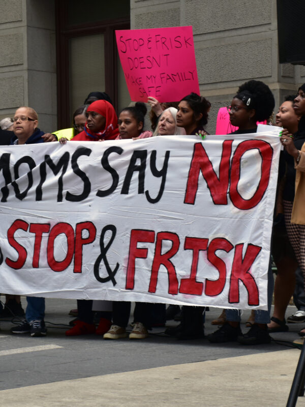 Group of demonstrators holding a banner reading "Moms say no to stop and frisk"