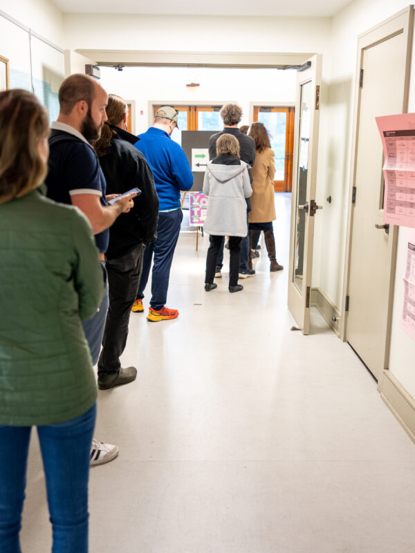 voters waiting in line at a polling station