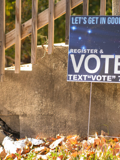 Yard sign showing Rep. John Lewis and encouraging people to vote