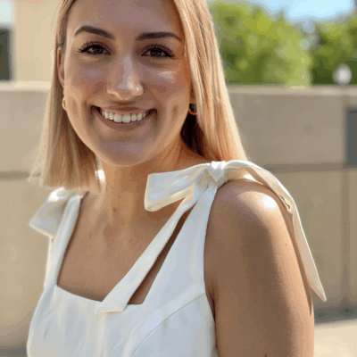 A picture of Sophia Schiaroli, smiling with short blonde hair and a white dress