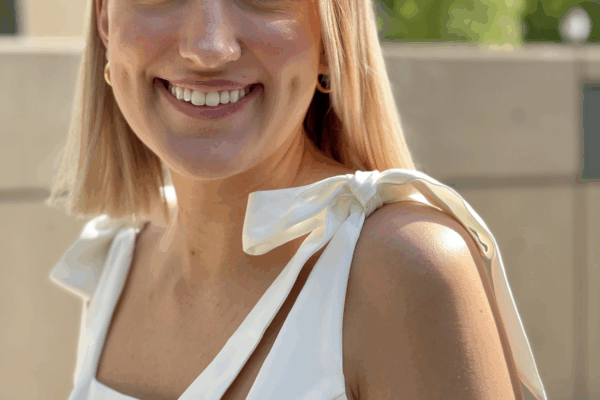 A picture of Sophia Schiaroli, smiling with short blonde hair and a white dress