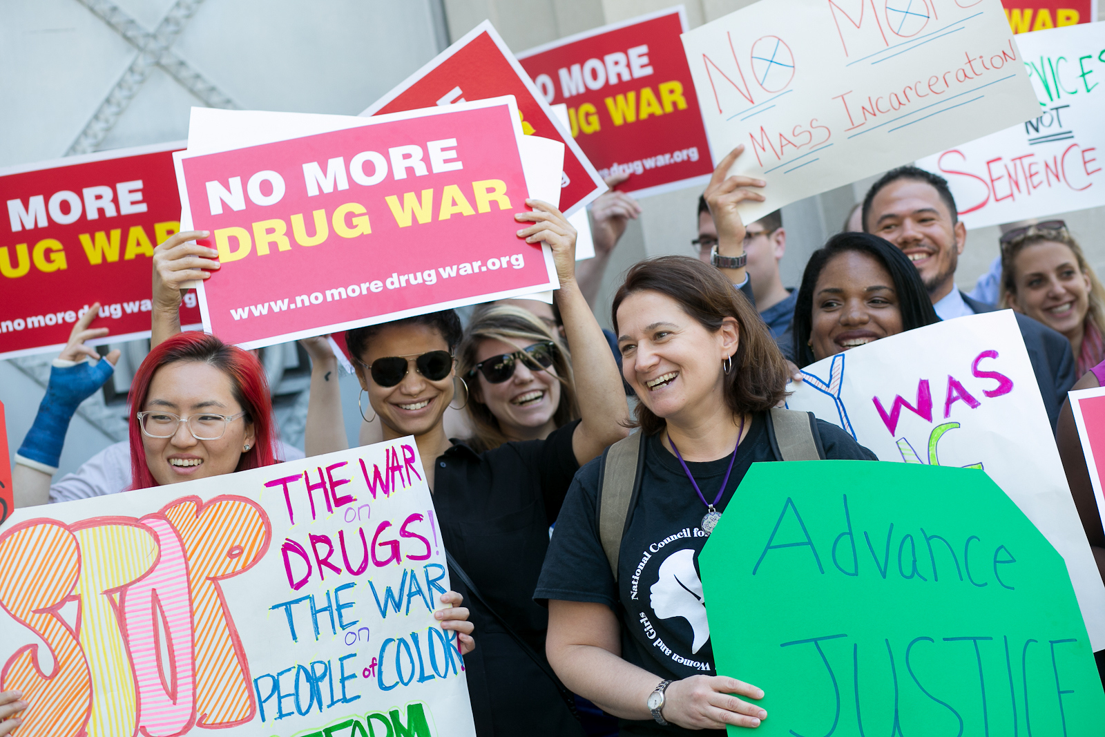 A group of people who have signs that says, "No more drug war".