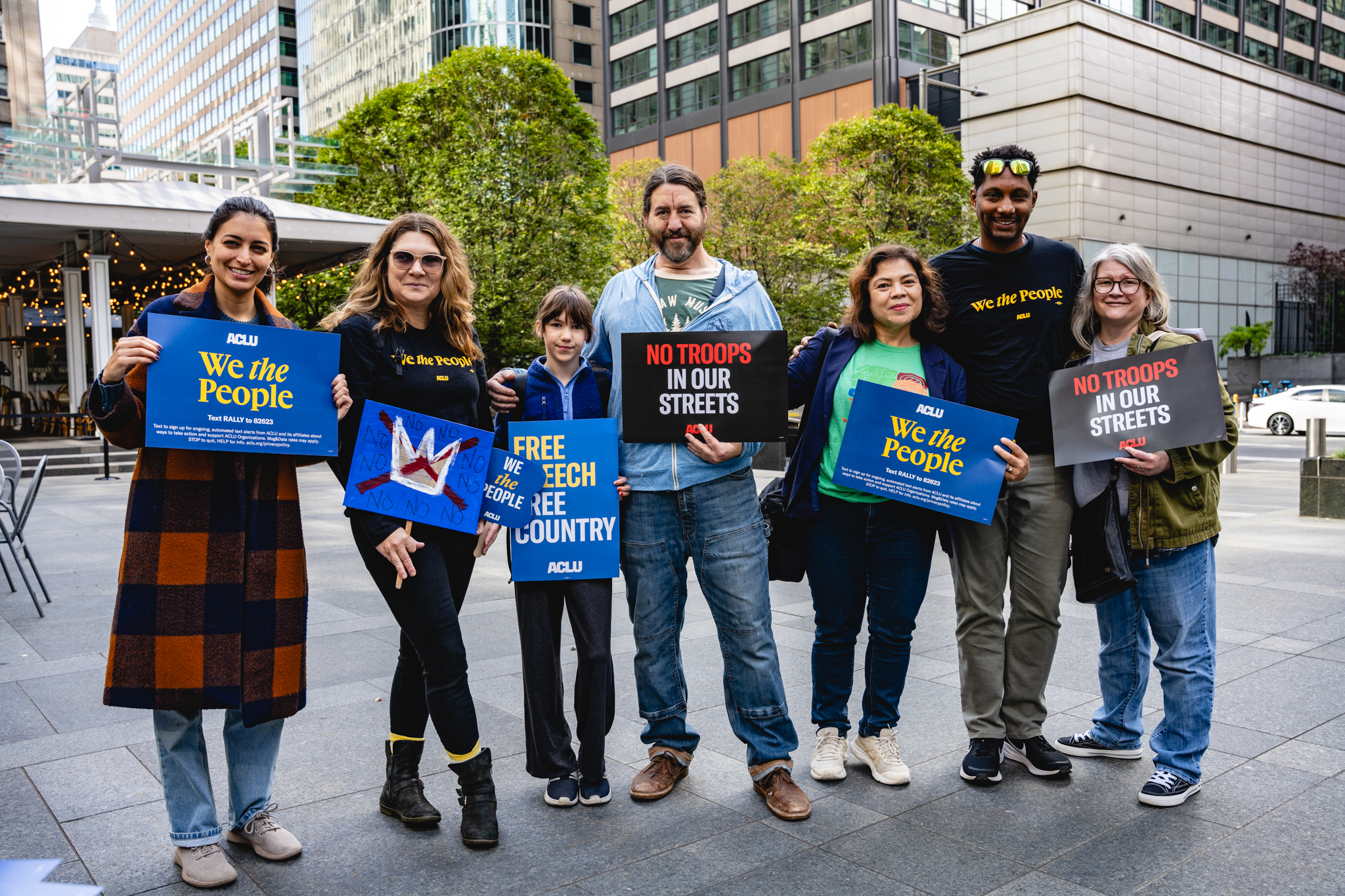 ACLU-PA staff and members holding up signs in front of the Comcast building in Philadelphia during the No Kings Protest in October 2025.