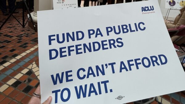 A photo of a sign that reads, “Fund PA public defenders. We can’t afford to wait.”