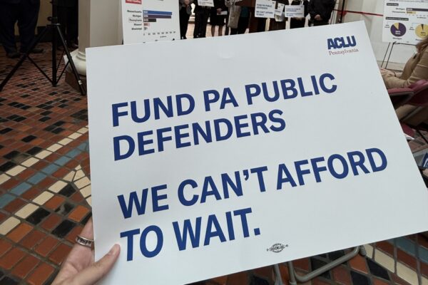 A photo of a sign that reads, “Fund PA public defenders. We can’t afford to wait.”