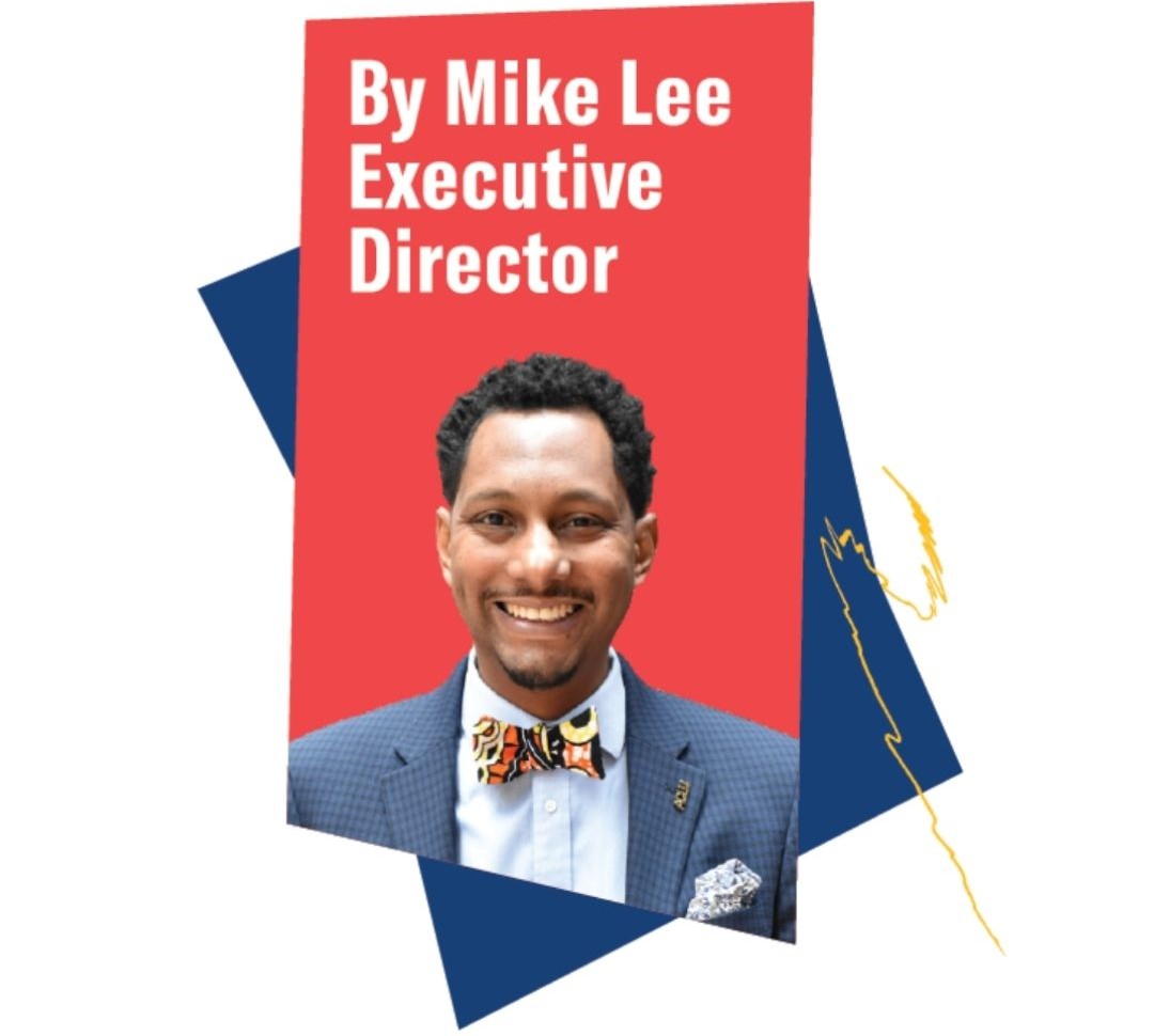 Portrait of Mike Lee, Executive Director, wearing a suit and a colorful bow tie.