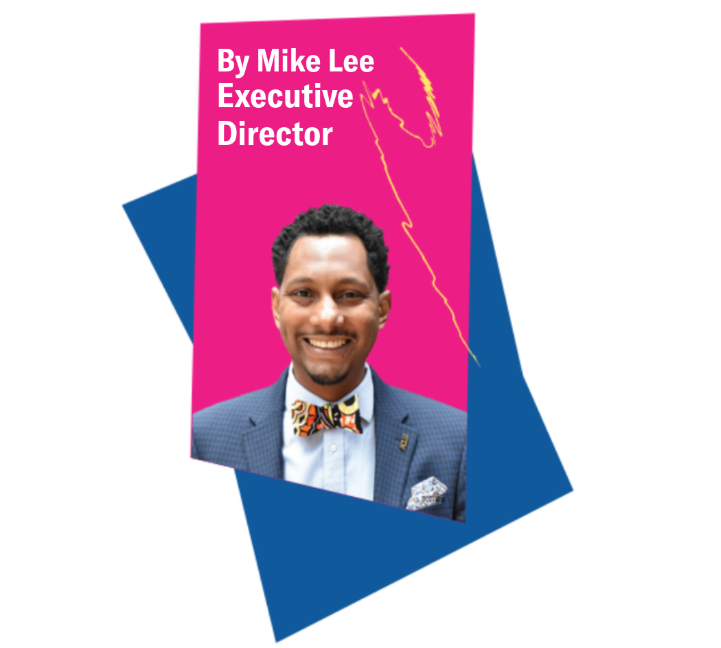 A headshot of ACLU-PA Executive Director Mike Lee. His photo is on a pink and blue background. He wears a blue suit and multicolor bow tie.