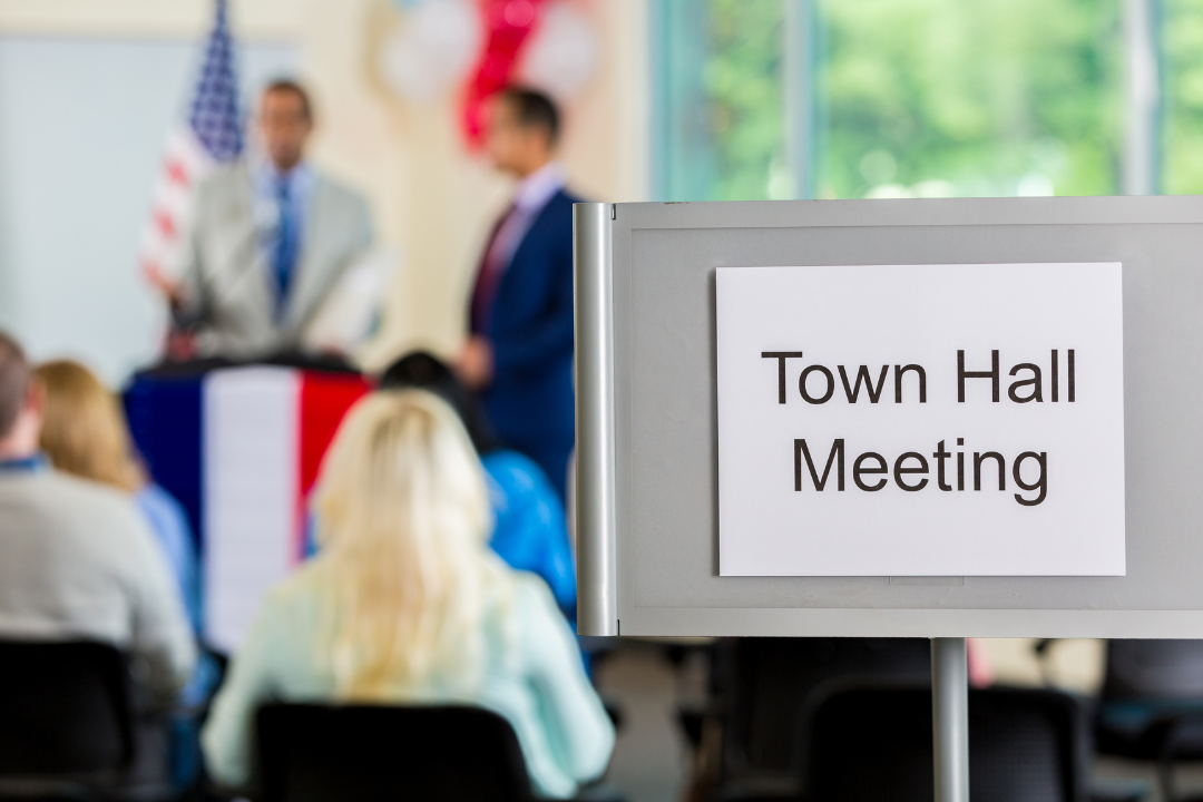 Image of a sign that says "Town hall meeting"