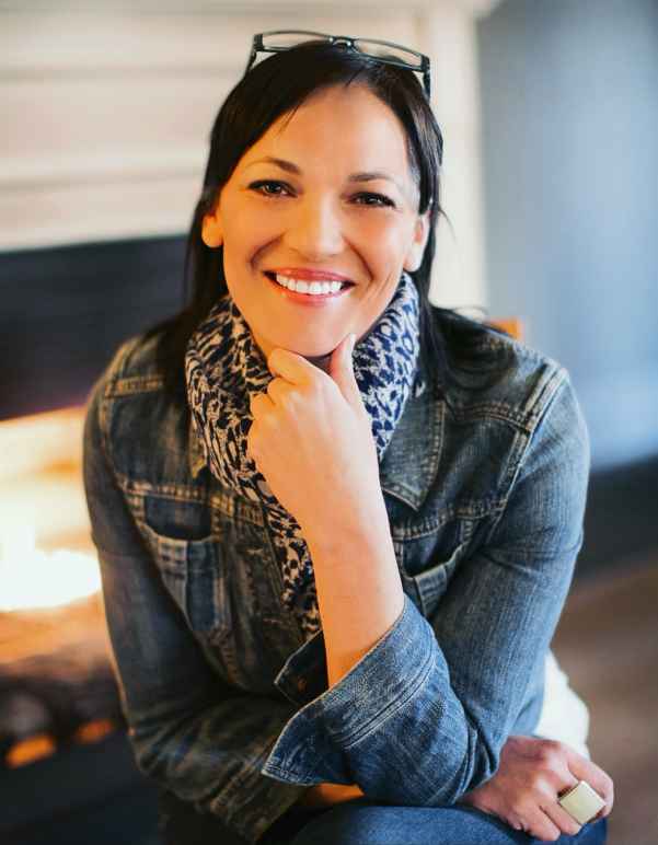 A picture of Elizabeth Randol smiling and sitting with a chair