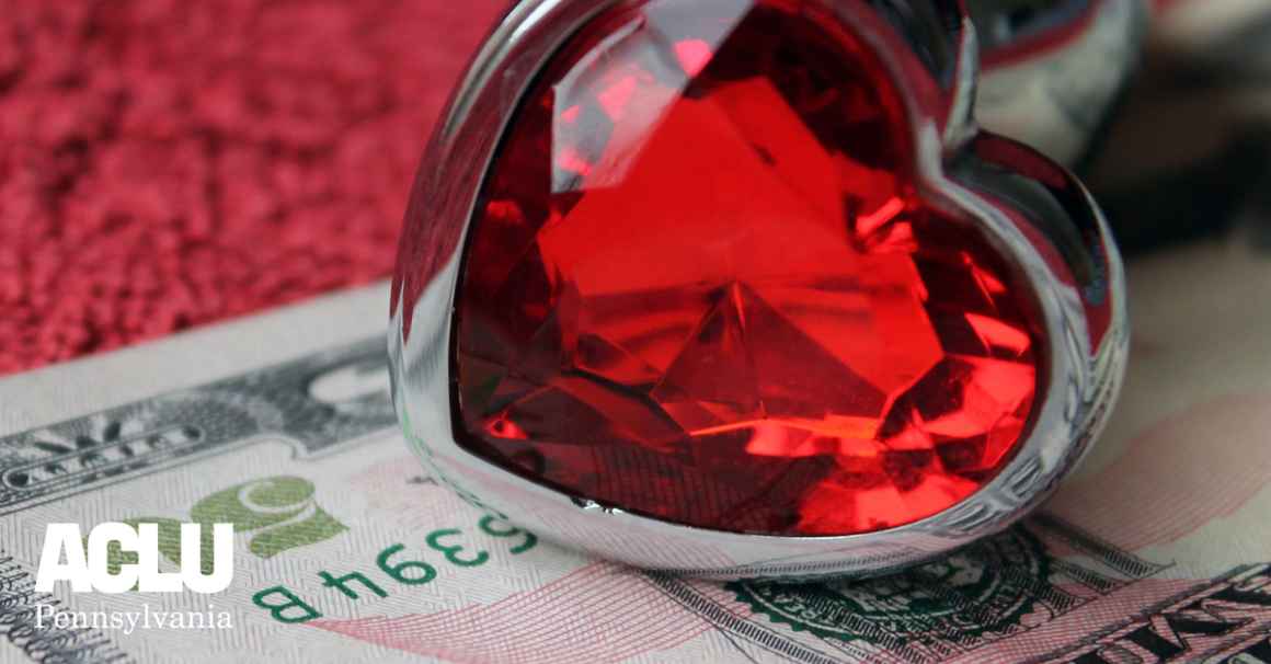 heart-shaped ring and fifty dollar bill