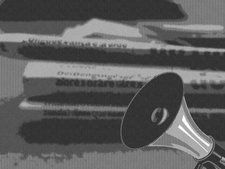 megaphone and stack of newspapers