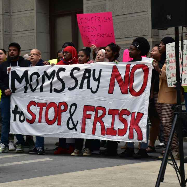 Group of demonstrators holding a banner reading "Moms say no to stop and frisk"