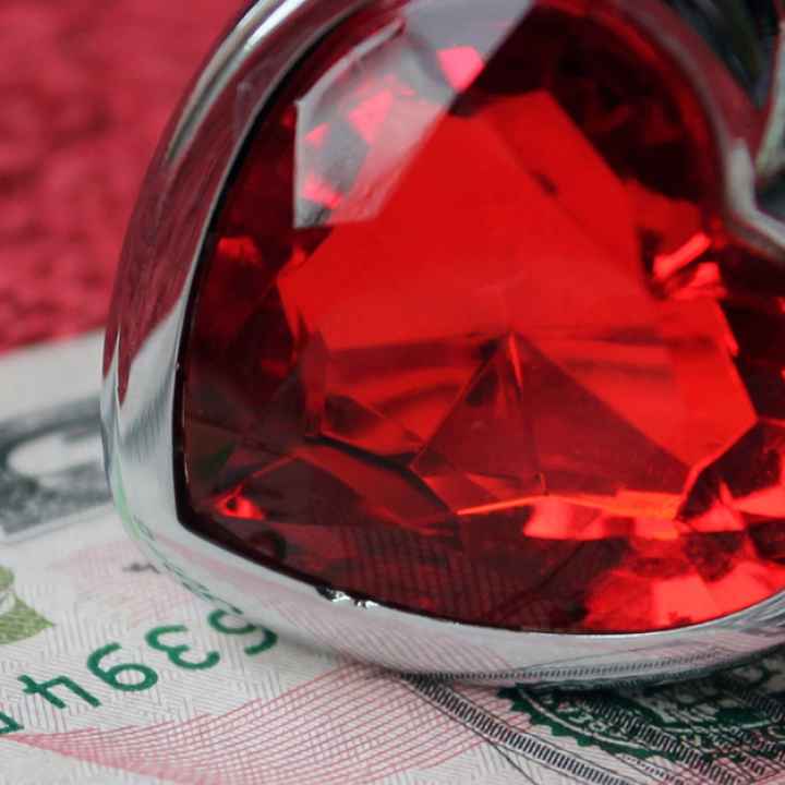 heart-shaped ring and fifty dollar bill